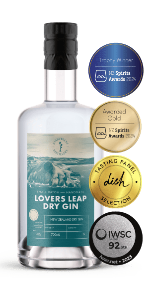 A clear glass bottle with clear liquid and a teal blue label titled "Lovers Leap Dry Gin". On the side are four medals of this gins achievements.