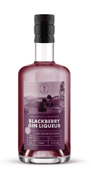 A clear glass bottle with deep purple liquid in it. On it is a purple label with illustrations of blackerry bushes, titled Blackberry Gin Liqueur.