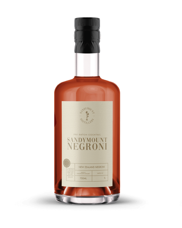 A clear glass bottle with red liquid and a beige label titled Sandymount Negroni