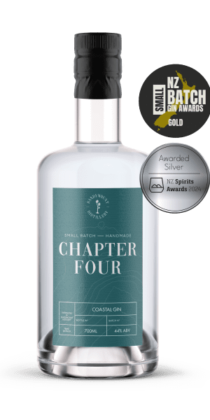 A clear glass bottle with a murky blue label on it that says Chapter Four gin