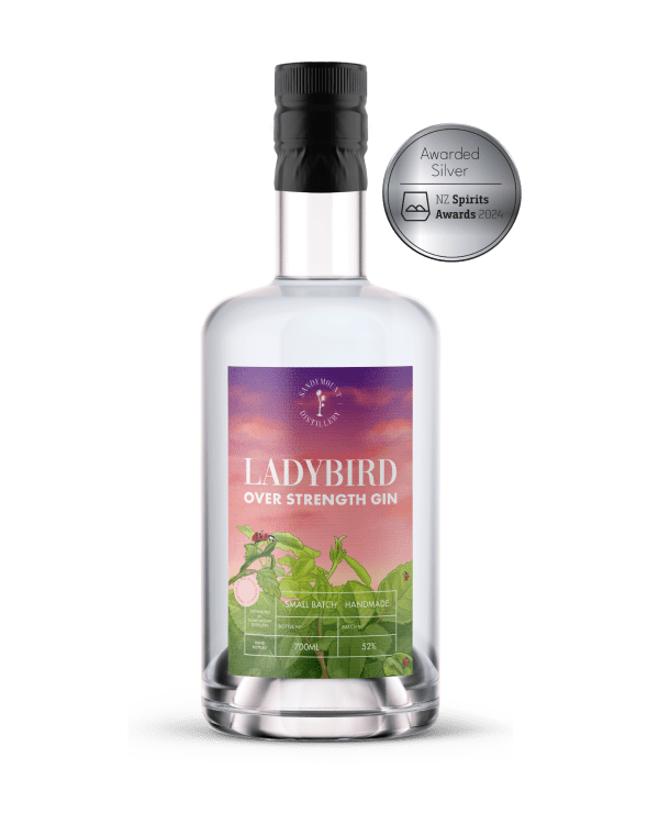 A glass bottle of Sandymount's Ladybird Navy Strength Gin with a vibrant pink and green label. A silver medal is to the right of the bottle.